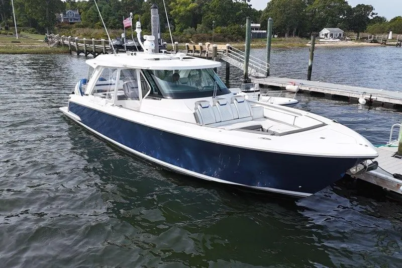 Carry On Yacht Photos Pics 2021 Tiara Sport 43 LS boat docked at a marina, featuring sleek design and spacious deck.