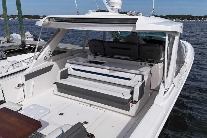 Carry On Yacht Photos Pics 2021 Tiara Sport 43 LS luxury boat with spacious seating and sleek design on the water.