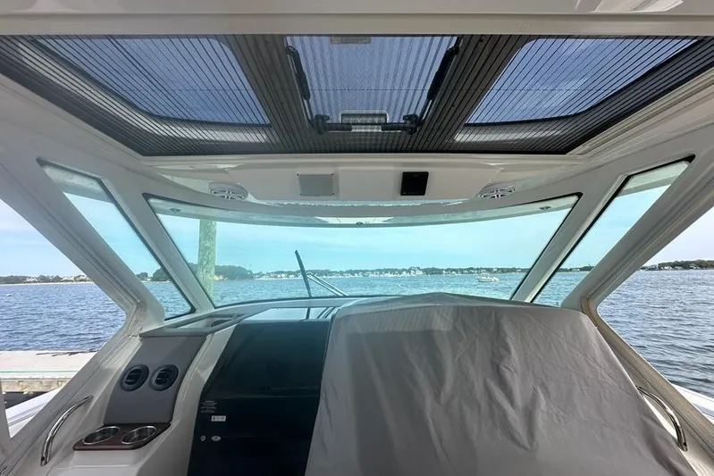 Carry On Yacht Photos Pics Interior view of 2021 Tiara Sport 43 LS yacht with panoramic windows and water backdrop.