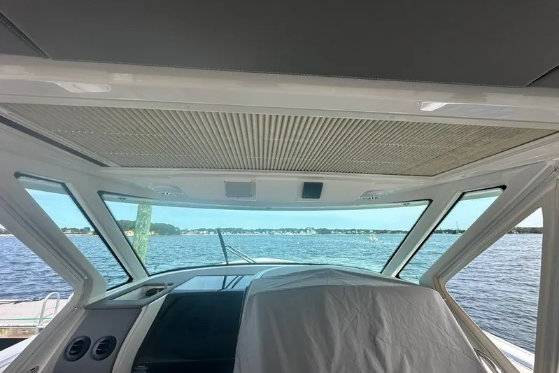 Carry On Yacht Photos Pics Interior view of 2021 Tiara Sport 43 LS yacht overlooking serene waters.