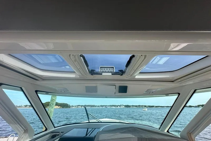 Carry On Yacht Photos Pics Interior view of 2021 Tiara Sport 43 LS yacht with panoramic windows and ocean scenery.