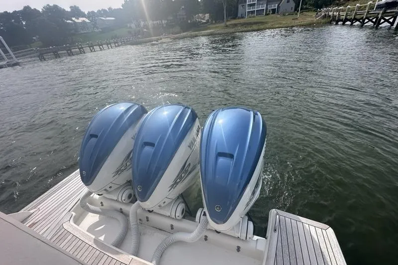 Carry On Yacht Photos Pics Triple Yamaha outboard engines on a 2021 Tiara Sport 43 LS boat by the water.