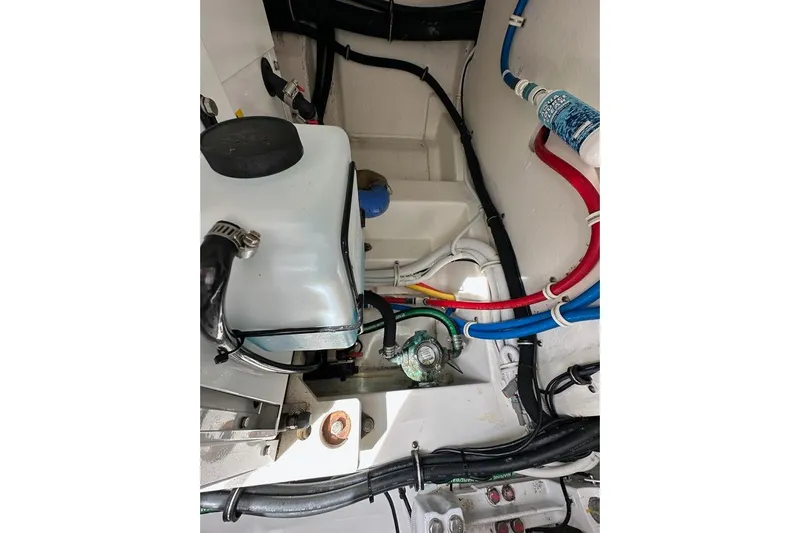 Carry On Yacht Photos Pics Engine compartment of a 2021 Tiara Sport 43 LS with visible hoses and components.