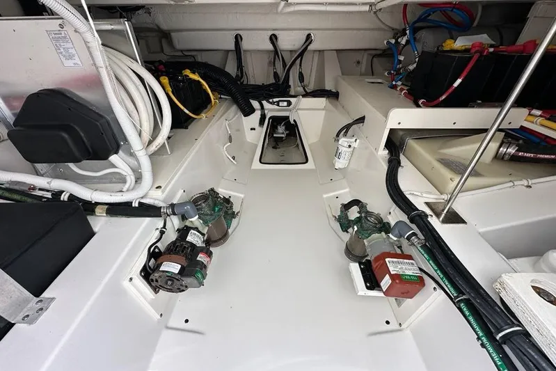 Carry On Yacht Photos Pics Engine compartment of a 2021 Tiara Sport 43 LS boat, showcasing wiring and components.