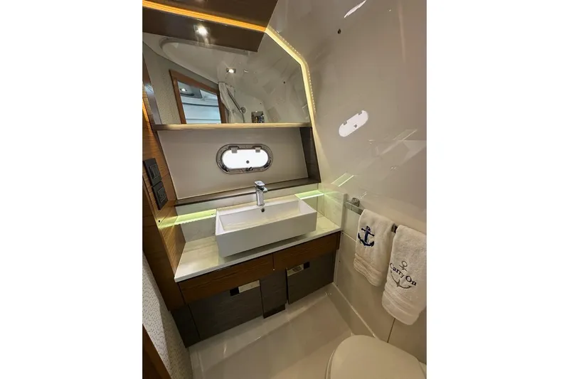 Carry On Yacht Photos Pics Luxurious bathroom in 2021 Tiara Sport 43 LS yacht with modern sink and elegant design.