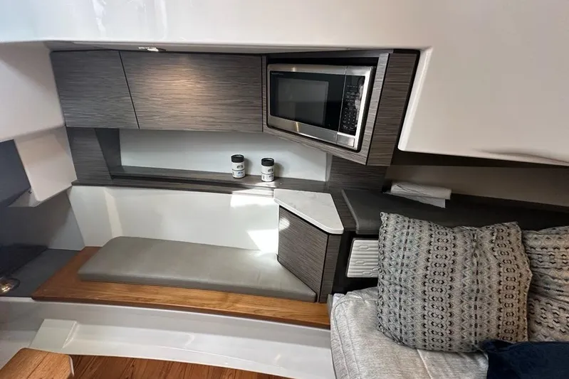 Carry On Yacht Photos Pics Interior of 2021 Tiara Sport 43 LS yacht with modern kitchenette and seating area.