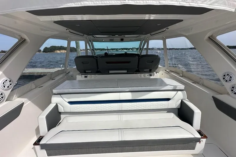 Carry On Yacht Photos Pics Interior view of 2021 Tiara Sport 43 LS yacht with luxurious seating and ocean backdrop.