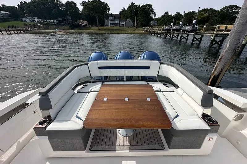Carry On Yacht Photos Pics Luxury seating area on a 2021 Tiara Sport 43 LS boat with wooden table.