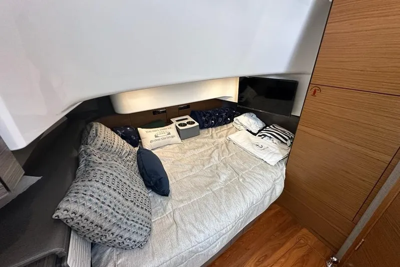 Carry On Yacht Photos Pics 2021 Tiara Sport 43 LS cabin interior with cozy bedding and modern design.