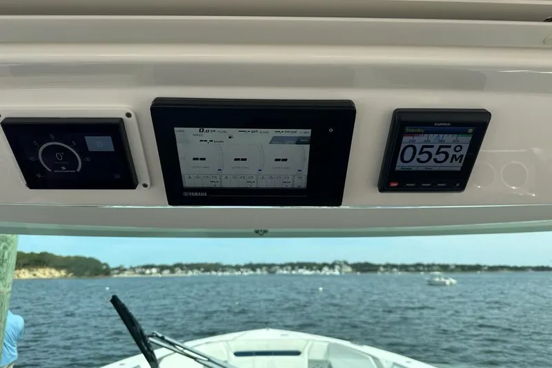 Carry On Yacht Photos Pics Dashboard of 2021 Tiara Sport 43 LS boat with digital displays and scenic water view.