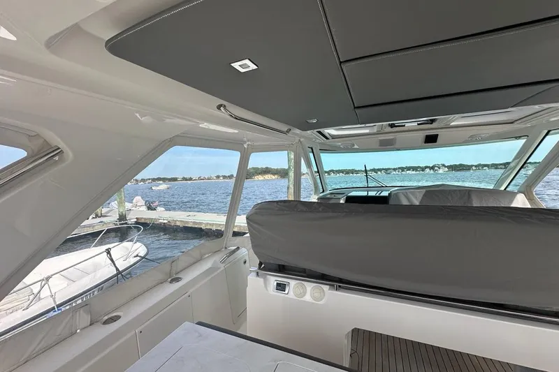 Carry On Yacht Photos Pics Interior view of 2021 Tiara Sport 43 LS yacht with scenic waterfront backdrop.
