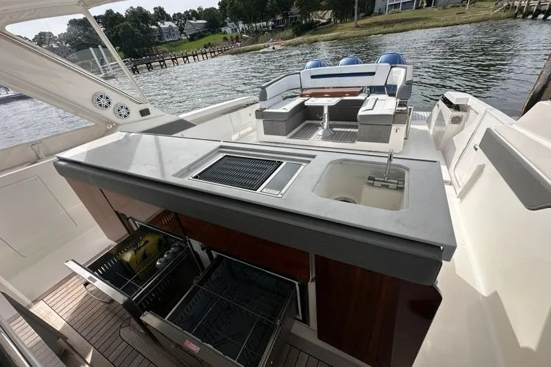 Carry On Yacht Photos Pics 2021 Tiara Sport 43 LS yacht with outdoor kitchen and seating area by the water.