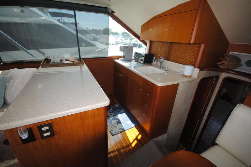  Yacht Photos Pics Interior of 1999 Ocean Yachts 45 Super Sport with kitchenette and seating area.