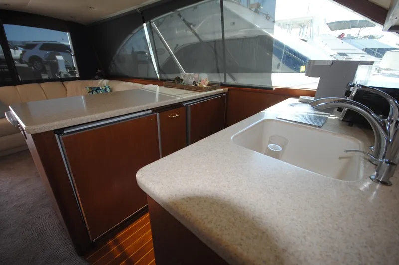  Yacht Photos Pics Interior of 1999 Ocean Yachts 45 Super Sport with kitchen and seating area.