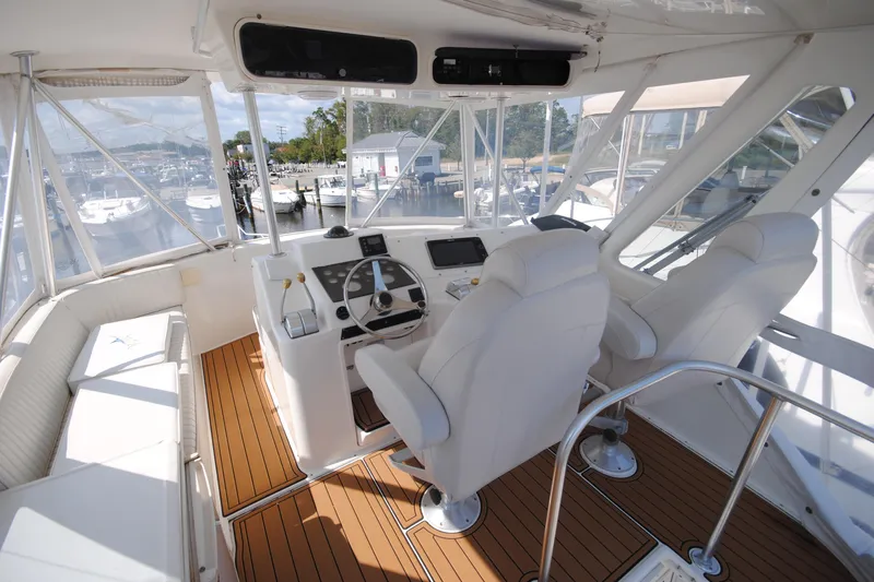  Yacht Photos Pics 1999 Ocean Yachts 45 Super Sport helm with white seating and wooden flooring.