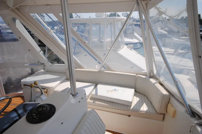  Yacht Photos Pics 1999 Ocean Yachts 45 Super Sport interior with seating and helm, featuring clear windows.