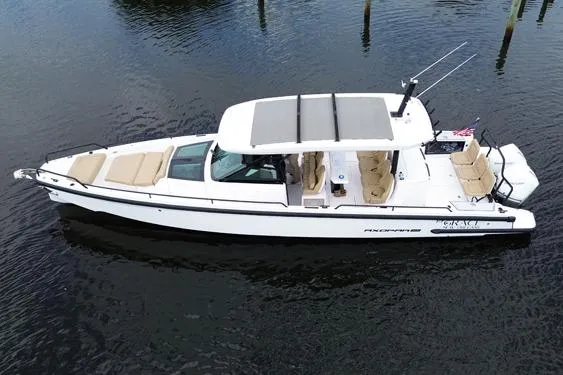 T/t Grace Yacht Photos Pics 2021 Axopar 37 Sun Top boat on calm water, featuring sleek design and spacious seating.