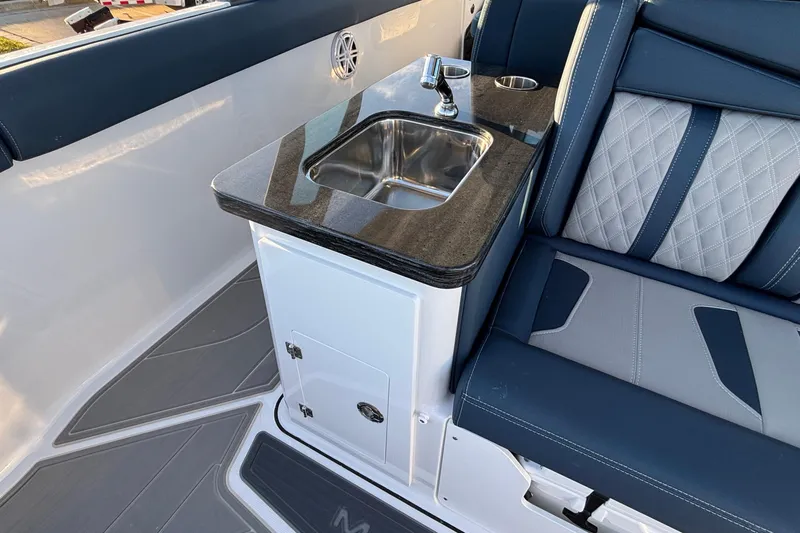  Yacht Photos Pics 2026 Monterey Elite 30 OB boat interior with sink and cushioned seating.