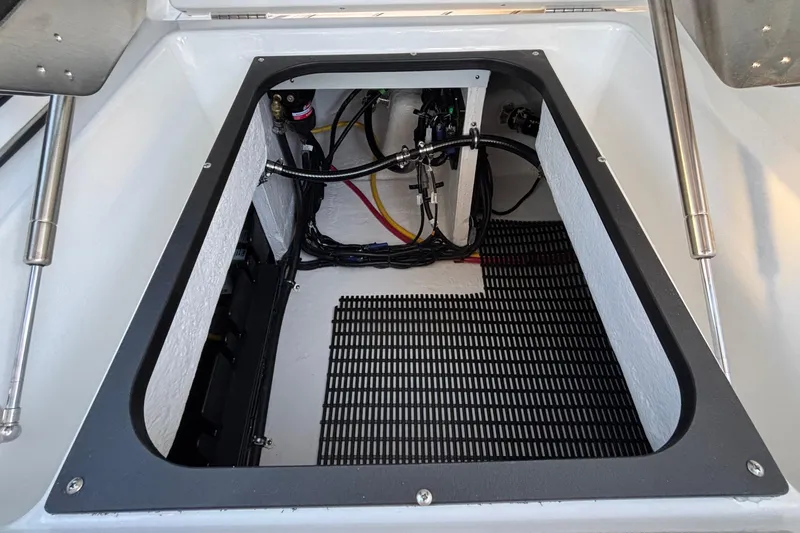  Yacht Photos Pics Open storage compartment in 2026 Monterey Elite 30 OB boat, showcasing wiring and equipment.