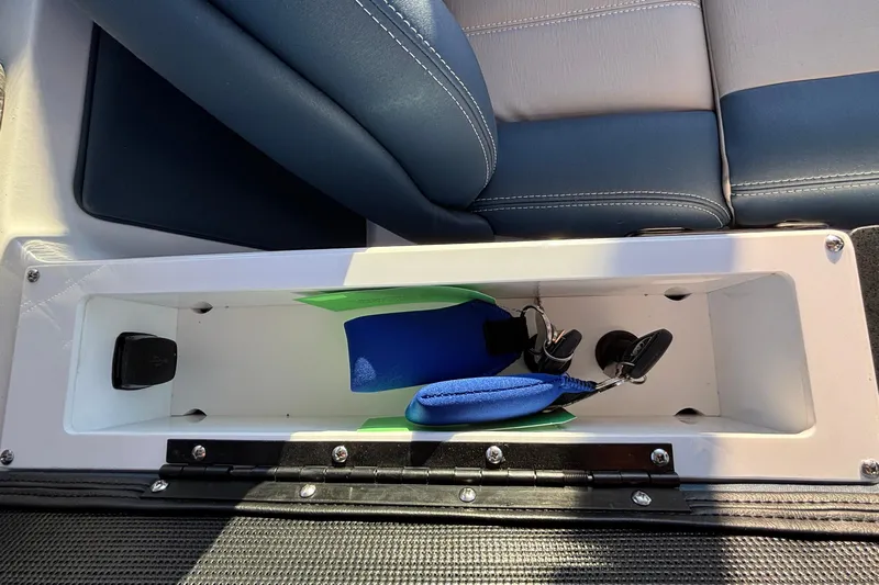  Yacht Photos Pics 2026 Monterey Elite 30 OB storage compartment with blue and green accessories.
