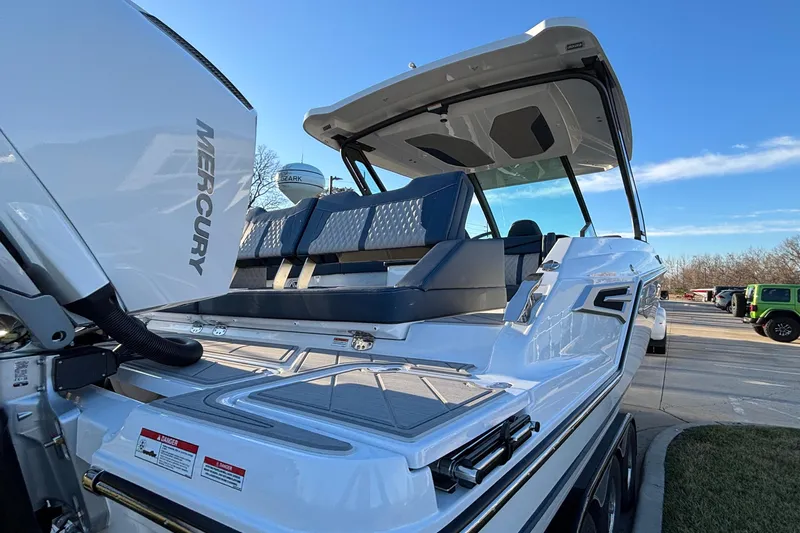  Yacht Photos Pics 2026 Monterey Elite 30 OB boat with Mercury engine, docked under clear blue sky.