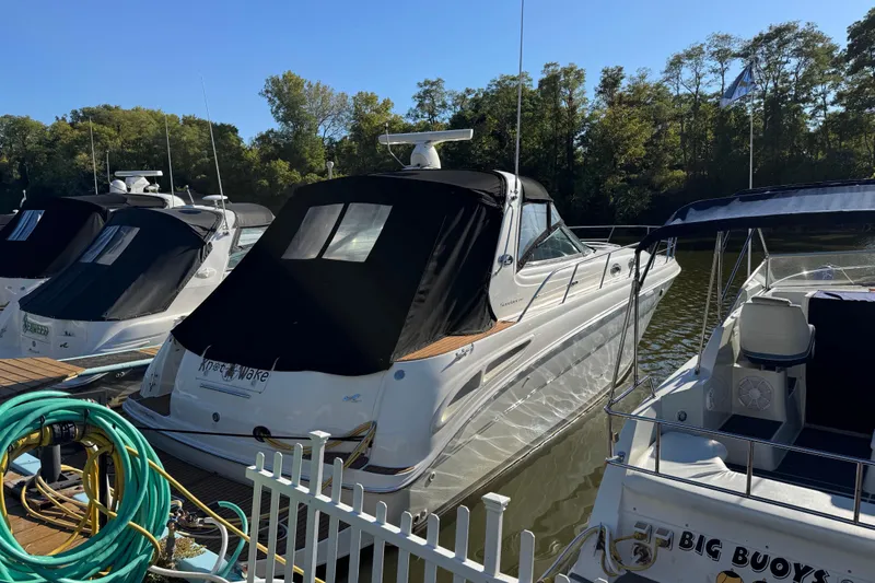  Yacht Photos Pics 2000 Sea Ray 380 Sundancer docked with other boats, surrounded by trees.