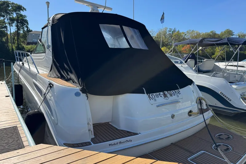  Yacht Photos Pics 2000 Sea Ray 380 Sundancer docked, featuring a black canvas cover and sleek design.