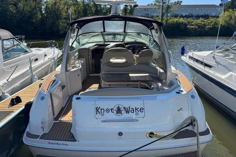  Yacht Photos Pics 2000 Sea Ray 380 Sundancer docked, featuring spacious seating and "Knot Wake" sign.