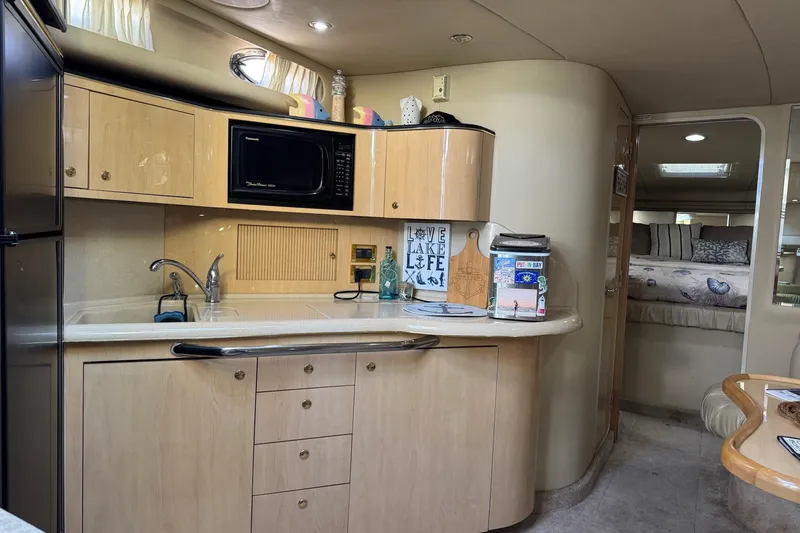 Yacht Photos Pics 2000 Sea Ray 380 Sundancer interior with kitchenette and cozy sleeping area.