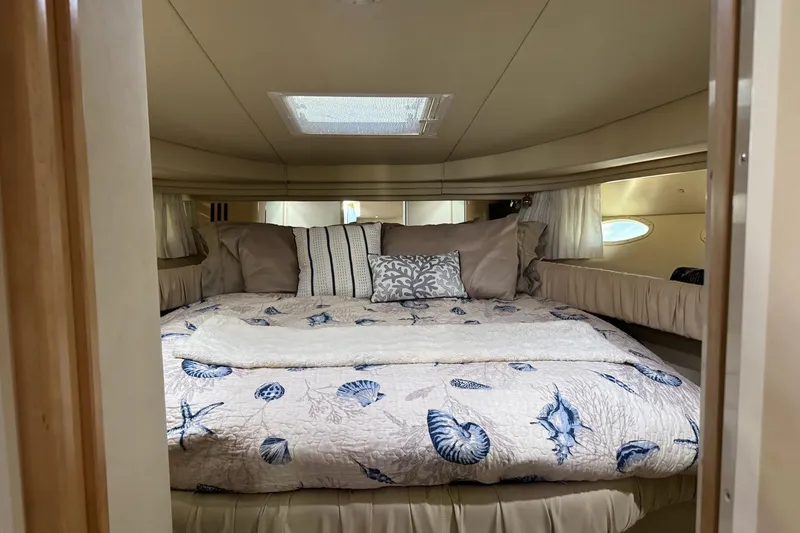  Yacht Photos Pics Luxurious cabin interior of 2000 Sea Ray 380 Sundancer yacht with cozy bedding.
