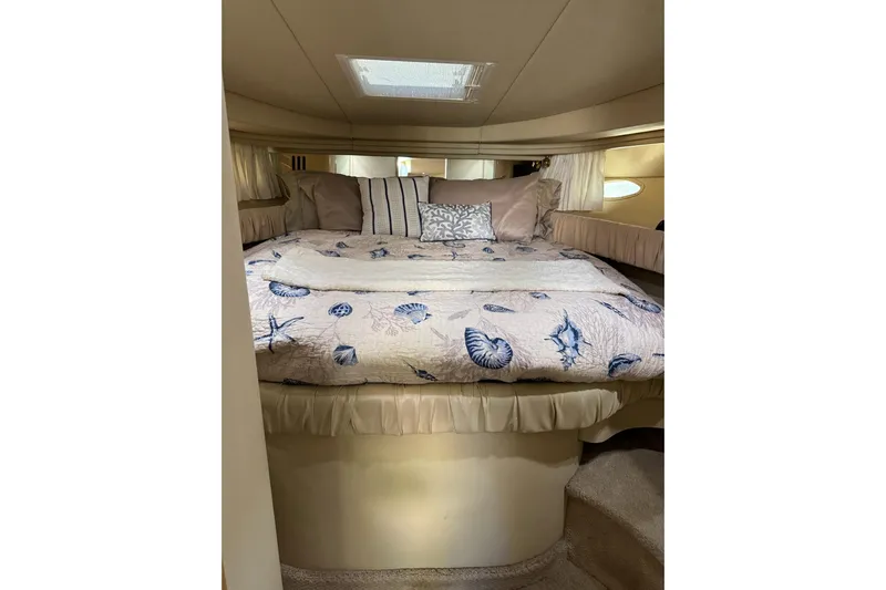  Yacht Photos Pics Cozy cabin interior of 2000 Sea Ray 380 Sundancer with nautical-themed bedding.