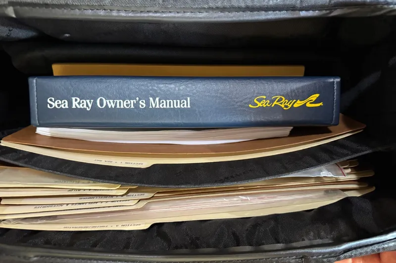  Yacht Photos Pics Sea Ray 380 Sundancer 2000 owner's manual in a binder with documents.