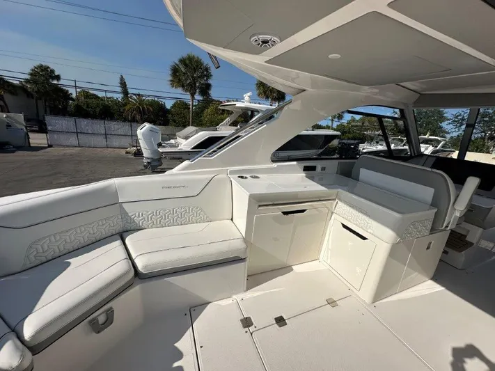  Yacht Photos Pics 2023 Regal LX36 boat interior with white seating and cabinetry, showcasing luxury design.