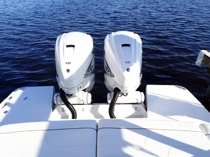  Yacht Photos Pics 2023 Regal LX36 boat with twin V8 engines on a calm water surface.