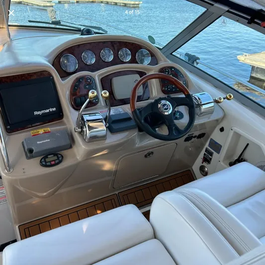  Yacht Photos Pics 2005 Sea Ray 340 Sundancer helm with Raymarine electronics and wood-accented dashboard.