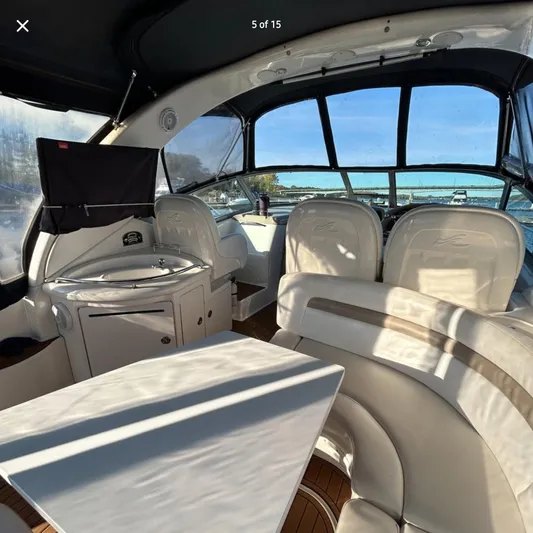  Yacht Photos Pics Interior of 2005 Sea Ray 340 Sundancer yacht with seating and table.