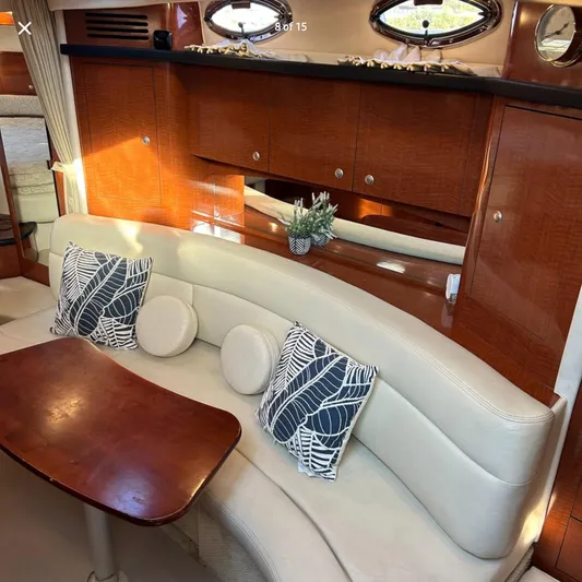  Yacht Photos Pics Interior of 2005 Sea Ray 340 Sundancer with elegant seating and wooden cabinetry.