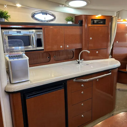  Yacht Photos Pics 2005 Sea Ray 340 Sundancer yacht interior kitchen with wood cabinets and modern appliances.