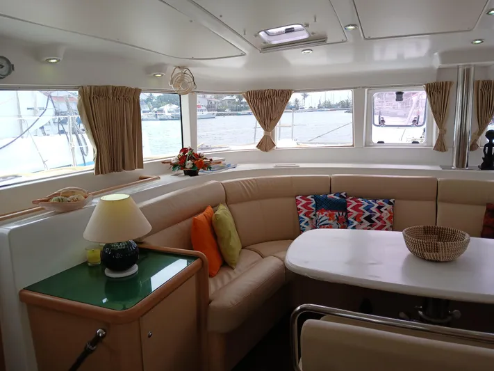 Patange II Yacht Photos Pics Interior of 2009 Lagoon 440 catamaran with cozy seating and decorative pillows.
