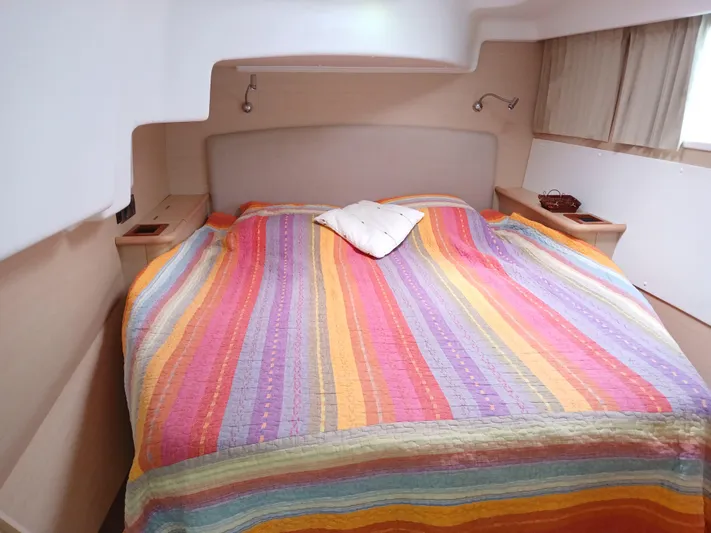 Patange II Yacht Photos Pics Cozy cabin bedroom in 2009 Lagoon 440 yacht with colorful striped bedding.