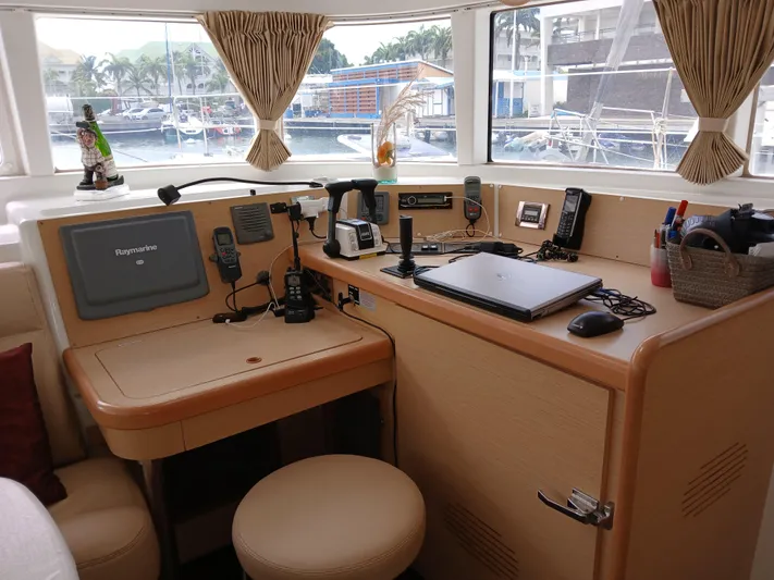 Patange II Yacht Photos Pics Interior of 2009 Lagoon 440 yacht with navigation equipment and cozy seating area.