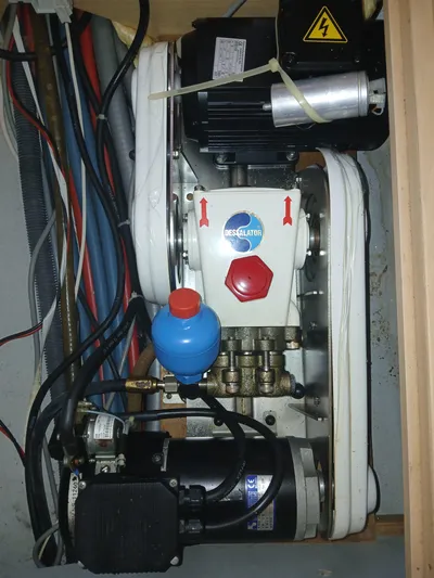 Patange II Yacht Photos Pics Engine compartment of a 2009 Lagoon 440 catamaran with visible wiring and components.