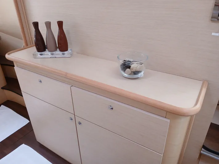 Patange II Yacht Photos Pics Cabinet with decorative vases and glass bowl in 2009 Lagoon 440 yacht interior.