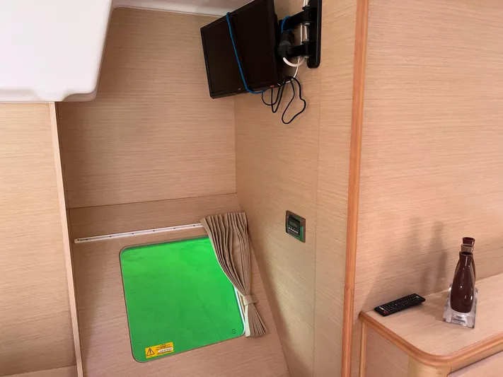 Patange II Yacht Photos Pics Interior of 2009 Lagoon 440 yacht cabin with window, TV, and remote control.