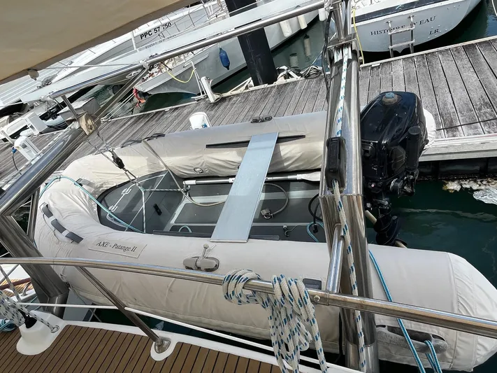 Patange II Yacht Photos Pics Inflatable boat docked beside Lagoon 440 catamaran, 2009 model, in a marina setting.