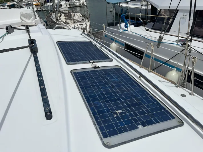 Patange II Yacht Photos Pics Lagoon 440 catamaran (2009) with solar panels on deck, docked at marina.