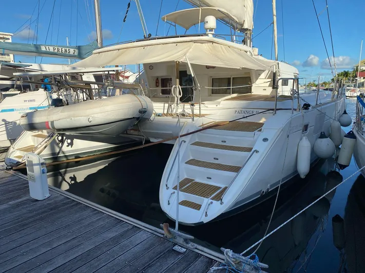 Patange II Yacht Photos Pics 2009 Lagoon 440 catamaran docked with inflatable dinghy, featuring spacious deck and modern design.
