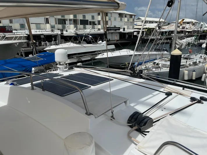Patange II Yacht Photos Pics Lagoon 440 catamaran, 2009 model, docked at marina with solar panels on deck.