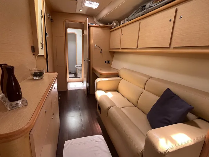 Patange II Yacht Photos Pics Luxurious interior of 2009 Lagoon 440 yacht with beige sofa and wooden cabinetry.