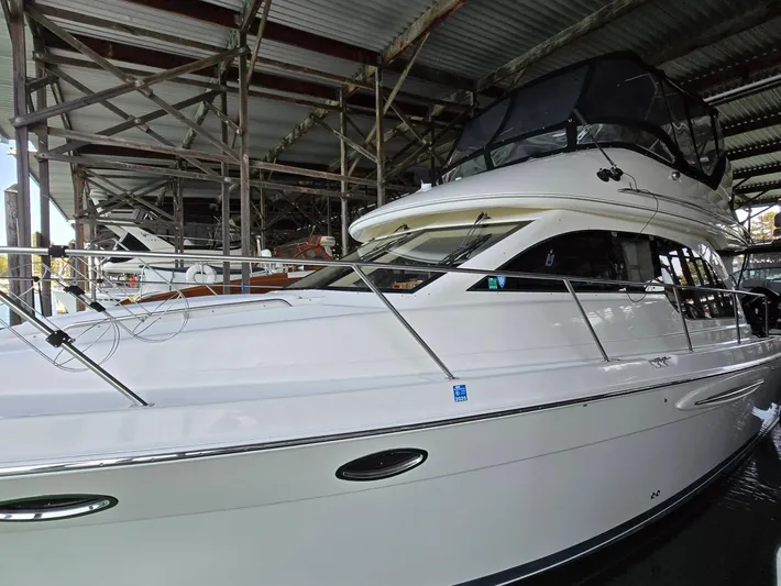 Mad Mary Yacht Photos Pics 2004 Meridian 381 Sedan yacht docked under a metal canopy.